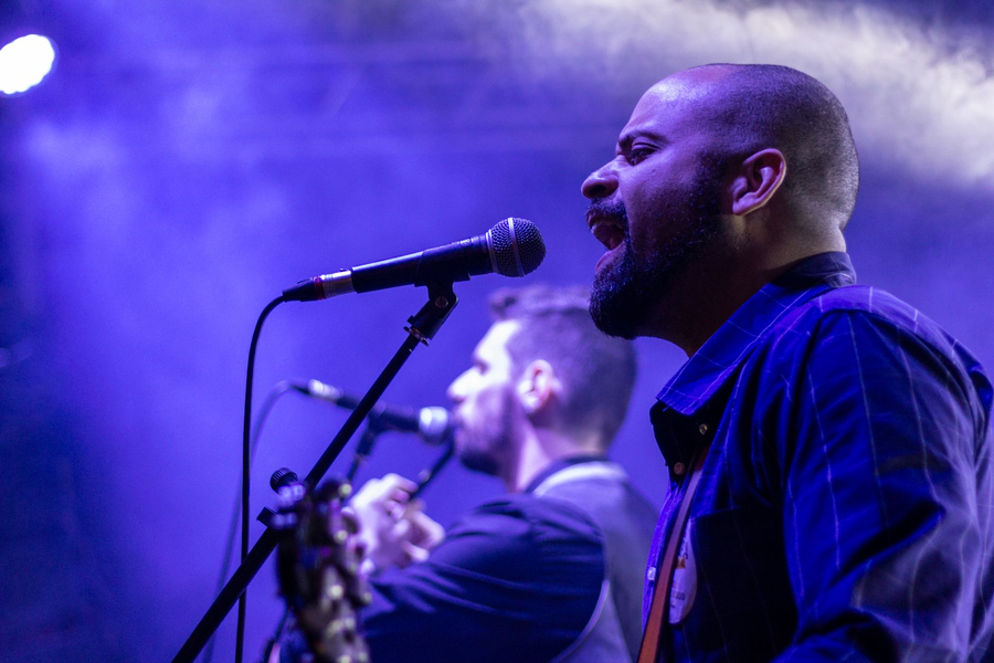 Singer performing on stage in warm light
