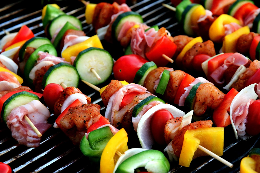 Shashlik skewers on a grill at a summer picnic