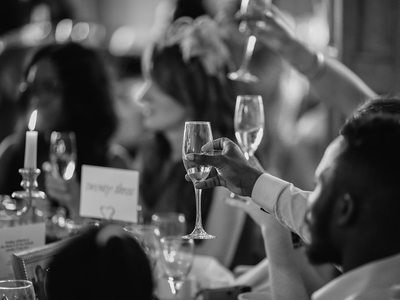 Wedding guests raising champagne glasses in a toast