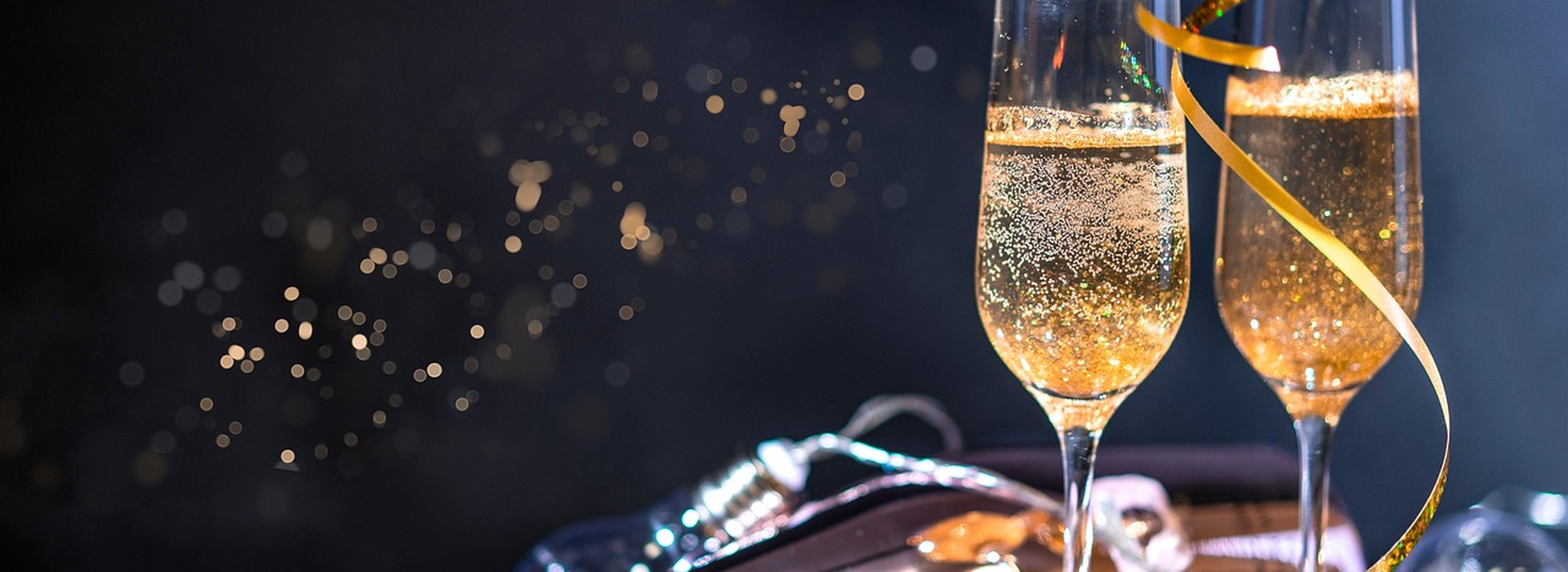 Festive banquet table with champagne glasses raised in a toast