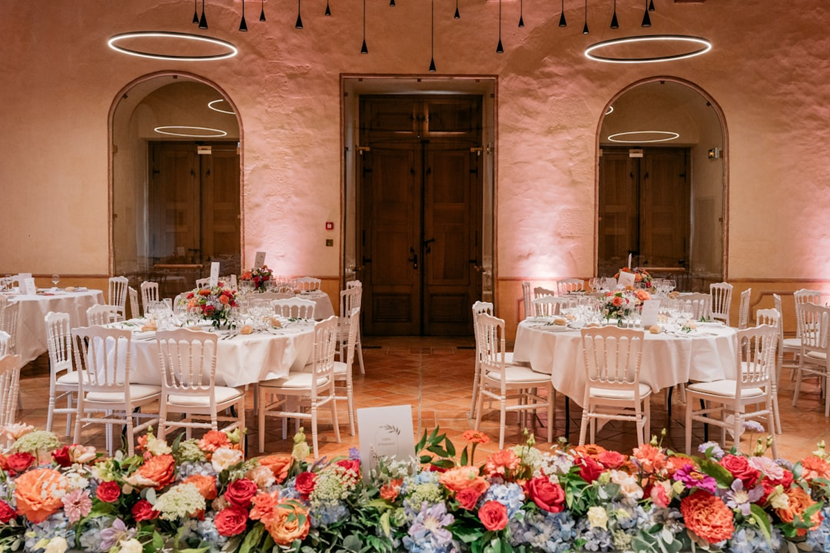 Decorated banquet hall with round tables ready for a celebration